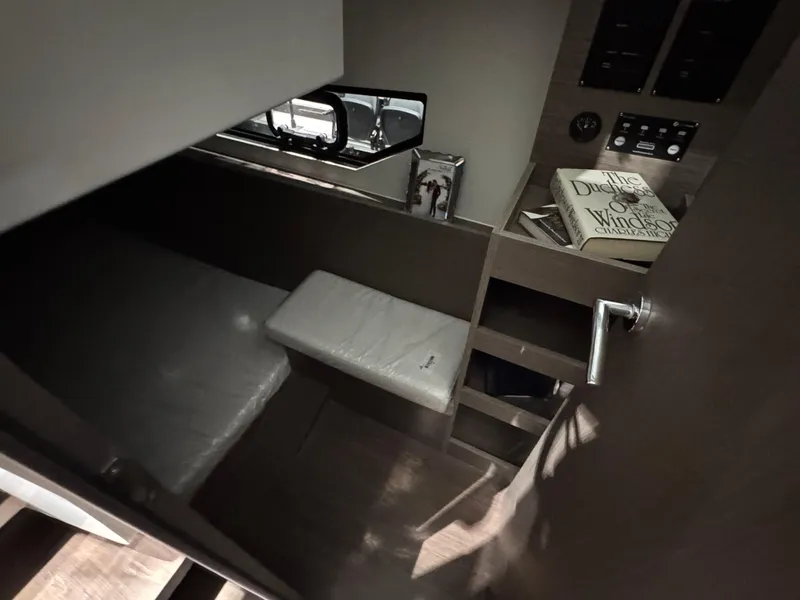 Slide: The Image of 2025 Jeanneau NC 895 Sport Series 2 cabin interior with bed and control panel. - 16