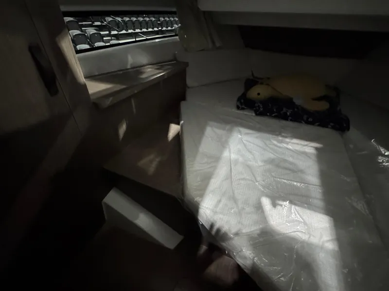 Slide: The Image of Interior cabin of 2025 Jeanneau NC 895 Sport Series 2 boat, featuring a cozy sleeping area. - 19