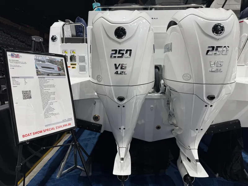 Slide: The Image of 2025 Jeanneau NC 895 Sport Series 2 with twin 250 V6 engines at boat show. - 2