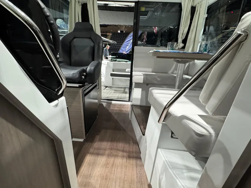 Slide: The Image of Interior of 2025 Jeanneau NC 895 Sport Series 2 boat, featuring seating and helm. - 24