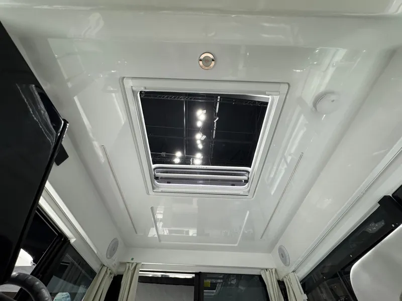 Slide: The Image of Interior view of 2025 Jeanneau NC 895 Sport Series 2, featuring a sleek skylight. - 25
