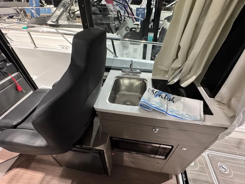 Slide: The Image of Interior of 2025 Jeanneau NC 895 Sport Series 2 with sink and seating. - 7
