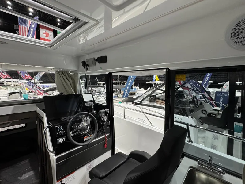 Slide: The Image of Interior of 2025 Jeanneau NC 895 Sport Series 2 boat, featuring helm and seating area. - 8