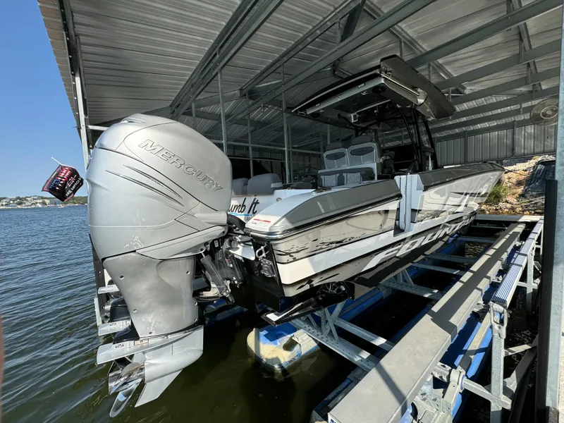 Slide: The Image of 2022 Fountain 38 SC boat with Mercury engine docked in a covered marina. - 4