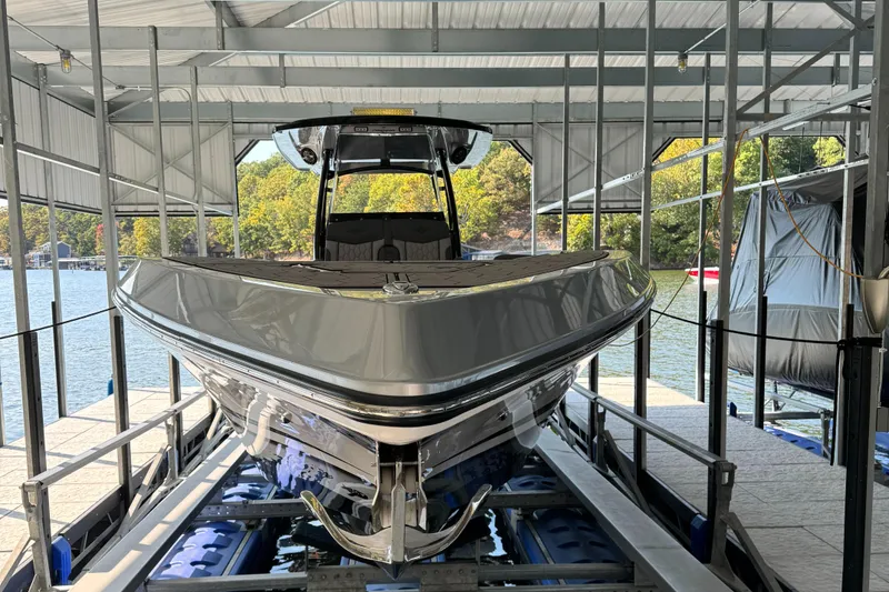 Slide: The Image of 2022 Fountain 38 SC boat docked in a covered marina. - 8