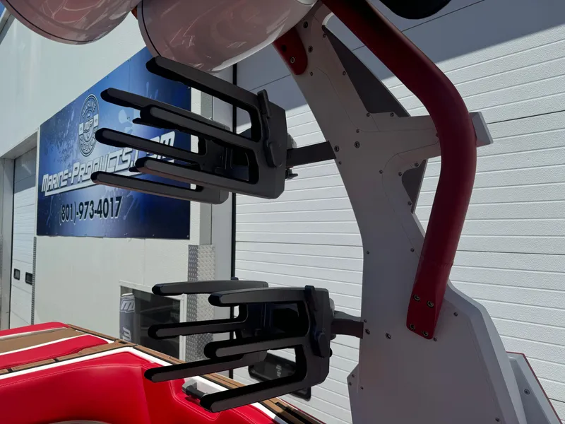 Slide: The Image of 2023 Supra SL 550 boat with wakeboard racks and red accents. - 10