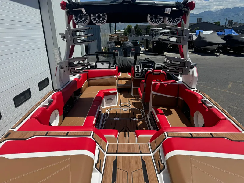 Slide: The Image of 2023 Supra SL 550 boat interior with red and tan seating, advanced sound system. - 5