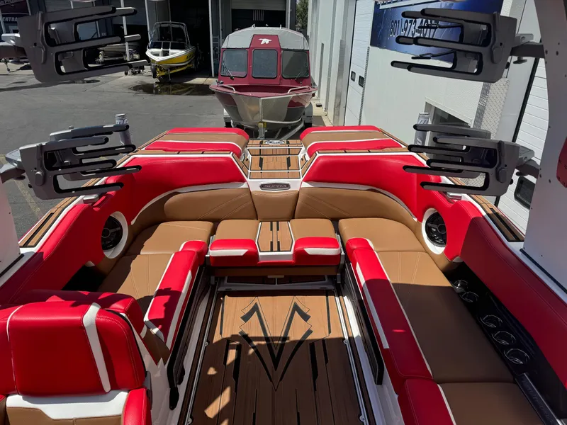 Slide: The Image of Luxurious 2023 Supra SL 550 boat interior with red and tan seating, docked at marina. - 7