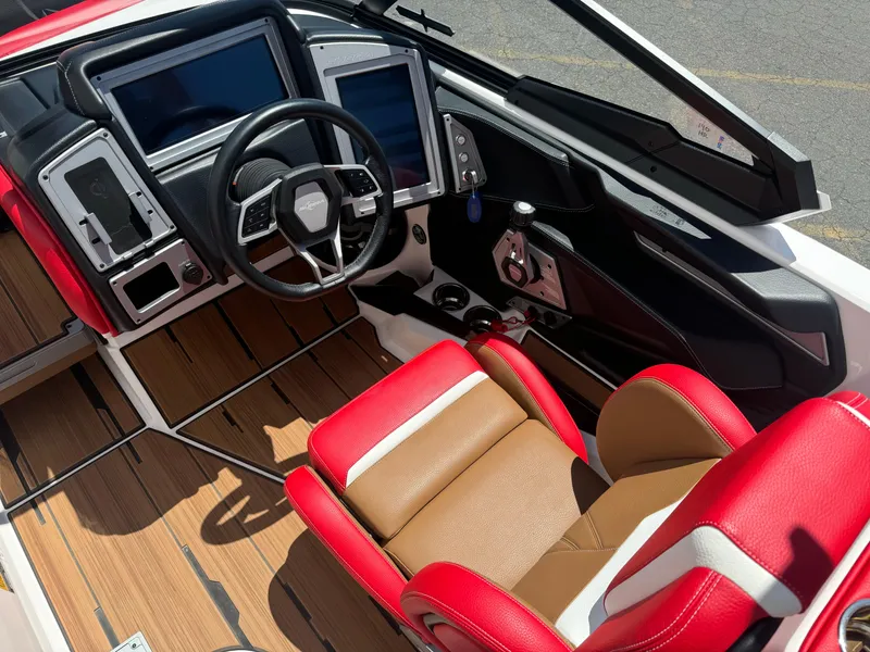 Slide: The Image of 2023 Supra SL 550 boat interior with red and brown seating, modern dashboard, and steering wheel. - 8