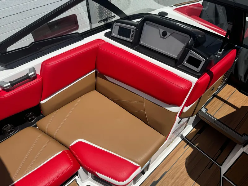 Slide: The Image of 2023 Supra SL 550 boat interior with red and tan seating, modern dashboard. - 9