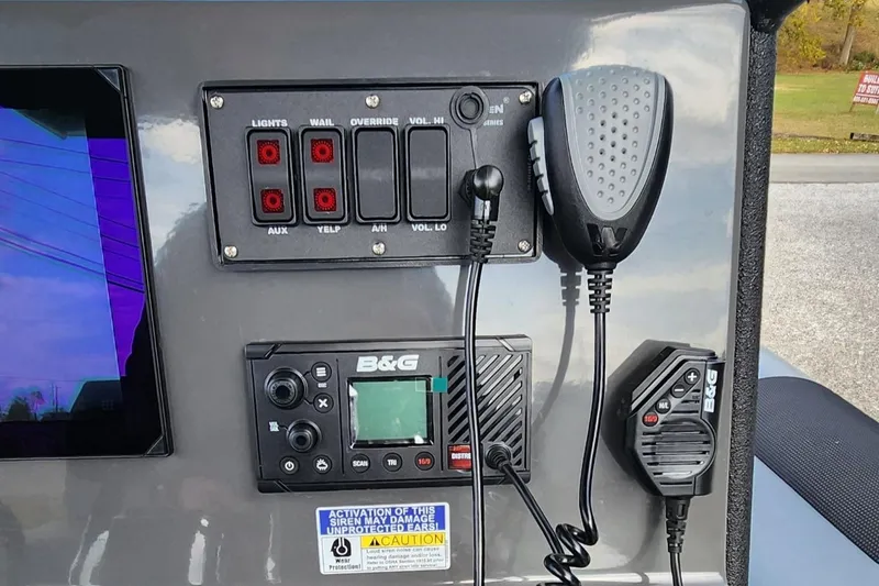 Slide: The Image of Control panel of 2025 Fluid Watercraft Patrol 26 with communication devices and switches. - 11