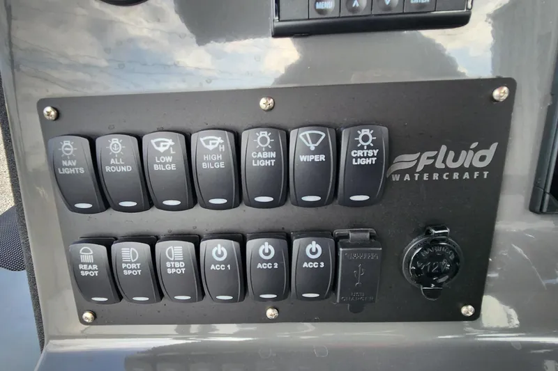 Slide: The Image of Control panel of 2025 Fluid Watercraft Patrol 26 with labeled switches and power socket. - 12