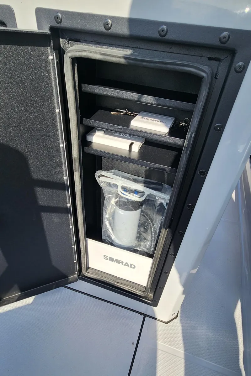 Slide: The Image of Storage compartment on 2025 Fluid Watercraft Patrol 26 with Simrad equipment. - 14