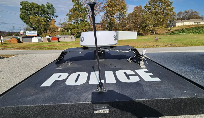 Slide: The Image of Police boat "Fluid Watercraft Patrol 26" on land, 2025 model, with autumn trees in background. - 16