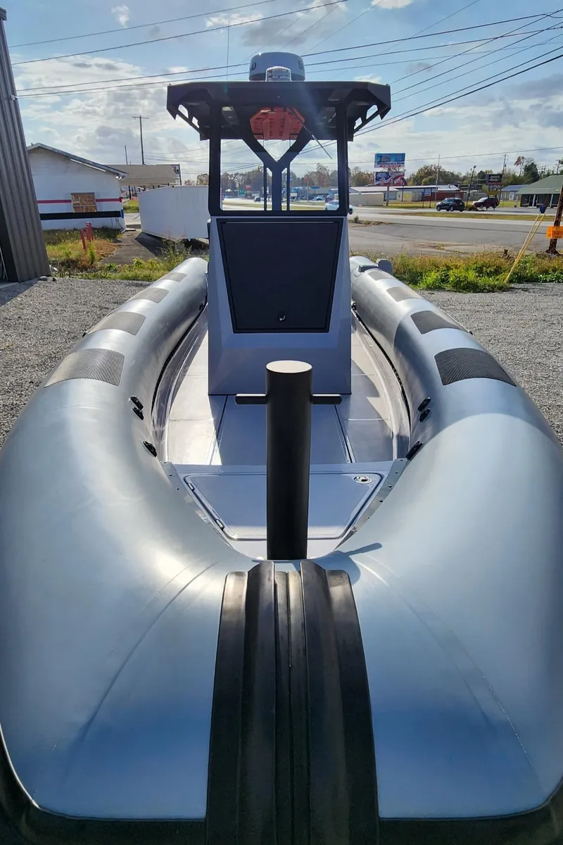 Slide: The Image of 2025 Fluid Watercraft Patrol 26 boat, sleek design, docked outdoors. - 3