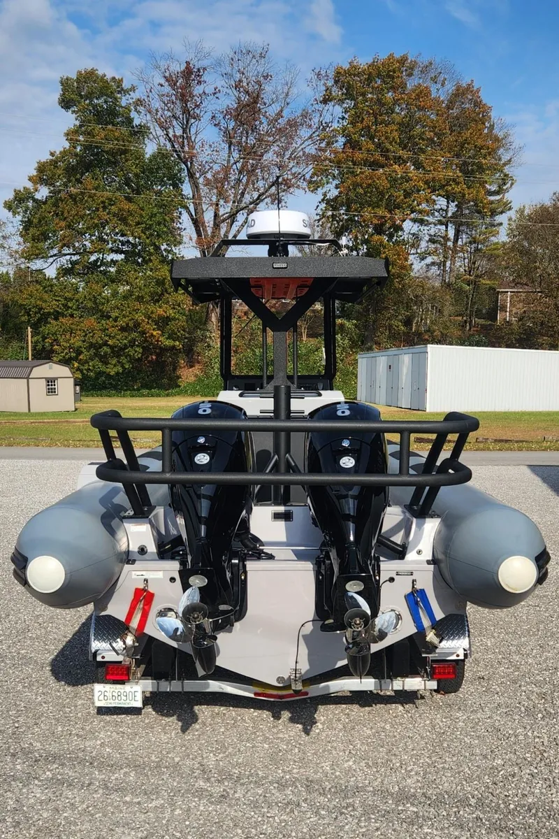 Slide: The Image of 2025 Fluid Watercraft Patrol 26 boat, rear view, parked outdoors. - 4