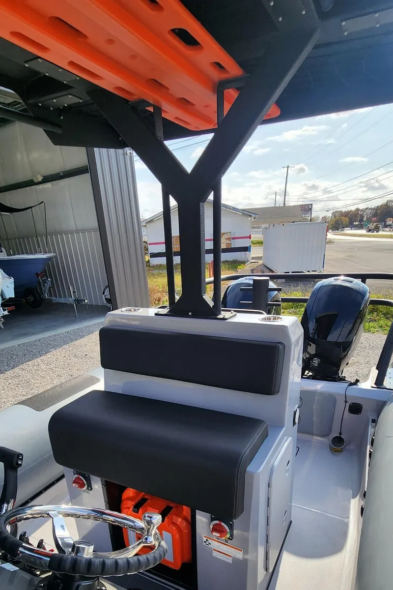 Slide: The Image of 2025 Fluid Watercraft Patrol 26 interior with seating and steering wheel. - 8