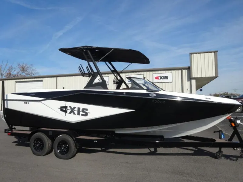 Slide: The Image of 2025 Axis T235 boat on trailer, black and white design, parked outdoors. - 1