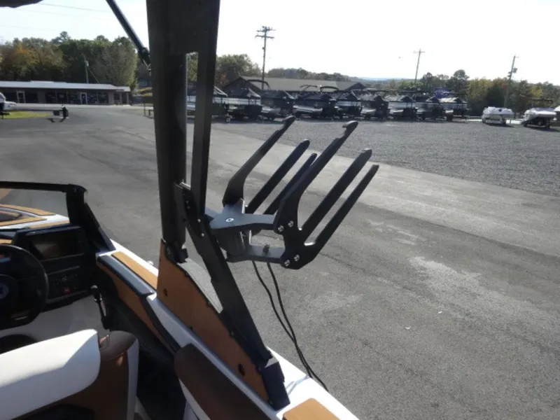 Slide: The Image of 2025 Axis T235 boat with wakeboard rack in a parking lot. - 11