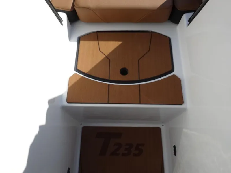 Slide: The Image of 2025 Axis T235 boat interior with brown seating and flooring. - 16