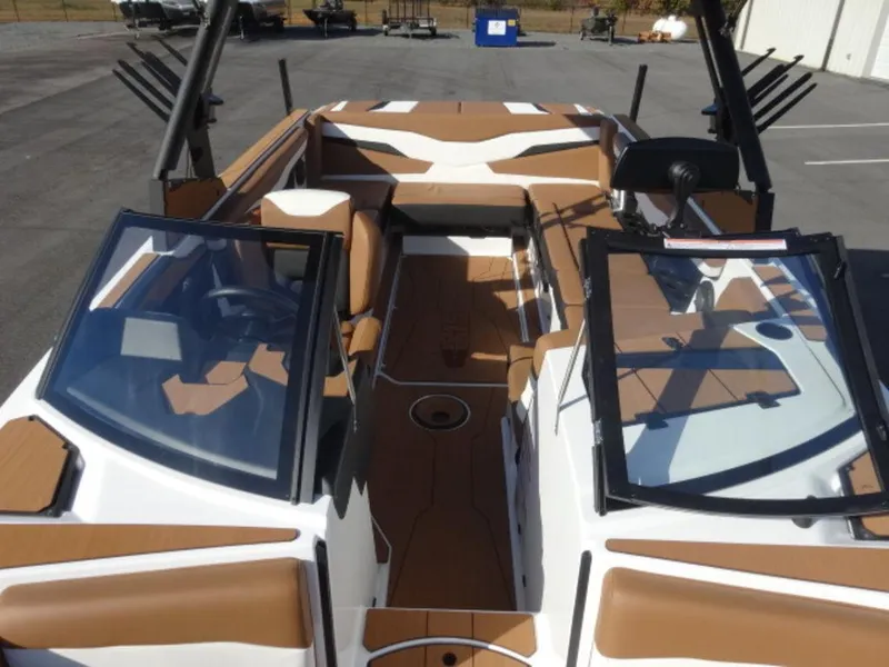 Slide: The Image of 2025 Axis T235 boat interior with brown and white seating, open windshield, and sleek design. - 18