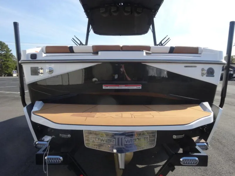 Slide: The Image of 2025 Axis T235 boat rear view with swim platform and seating. - 2