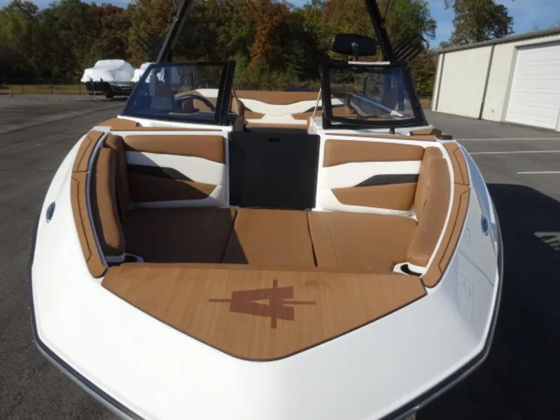 Slide: The Image of 2025 Axis T235 boat with tan and white interior, parked outdoors. - 22