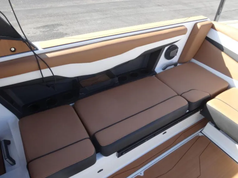 Slide: The Image of 2025 Axis T235 boat interior with brown cushioned seating. - 7