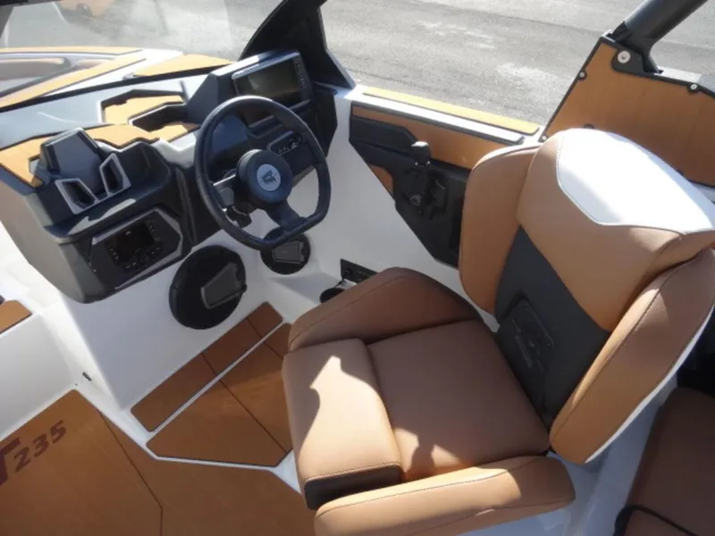 Slide: The Image of Interior of 2025 Axis T235 boat with modern steering and tan seating. - 8