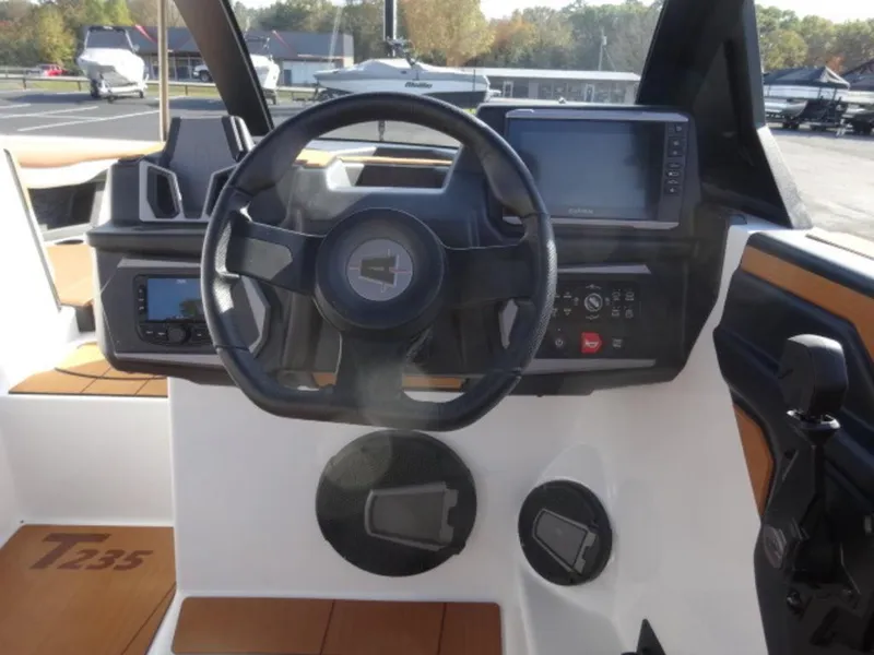 Slide: The Image of 2025 Axis T235 boat dashboard with steering wheel and electronic controls. - 9