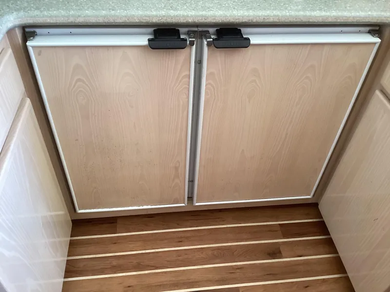 Slide: The Image of Wooden cabinet doors on a 2006 Henriques 35 Flybridge boat interior. - 10