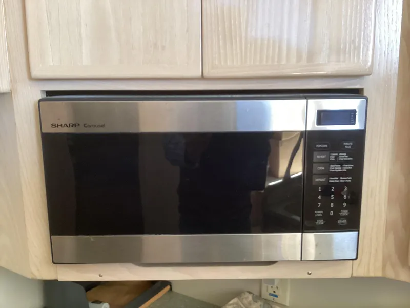 Slide: The Image of Built-in Sharp microwave with stainless steel finish in a kitchen setting. - 11