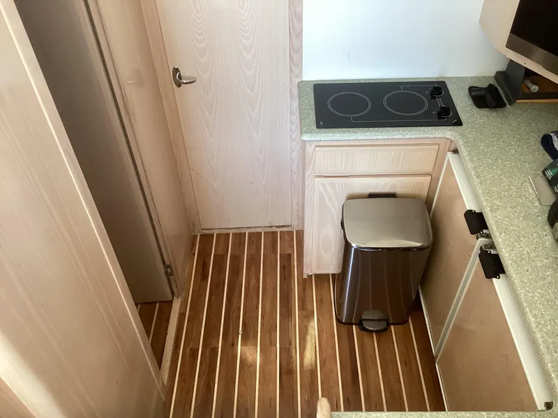 Slide: The Image of Henriques 35 Flybridge 2006 kitchen interior with wood flooring and modern appliances. - 12