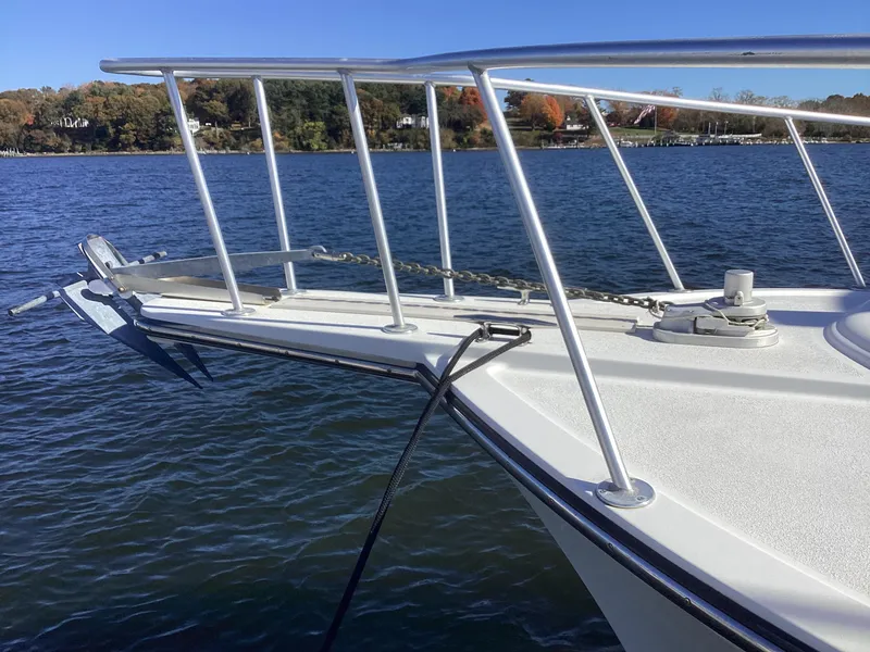 Slide: The Image of Henriques 35 Flybridge 2006 boat bow with anchor and railing on calm water. - 13