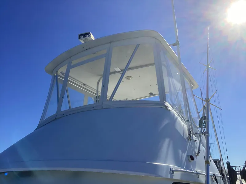Slide: The Image of 2006 Henriques 35 Flybridge boat under clear blue sky. - 16