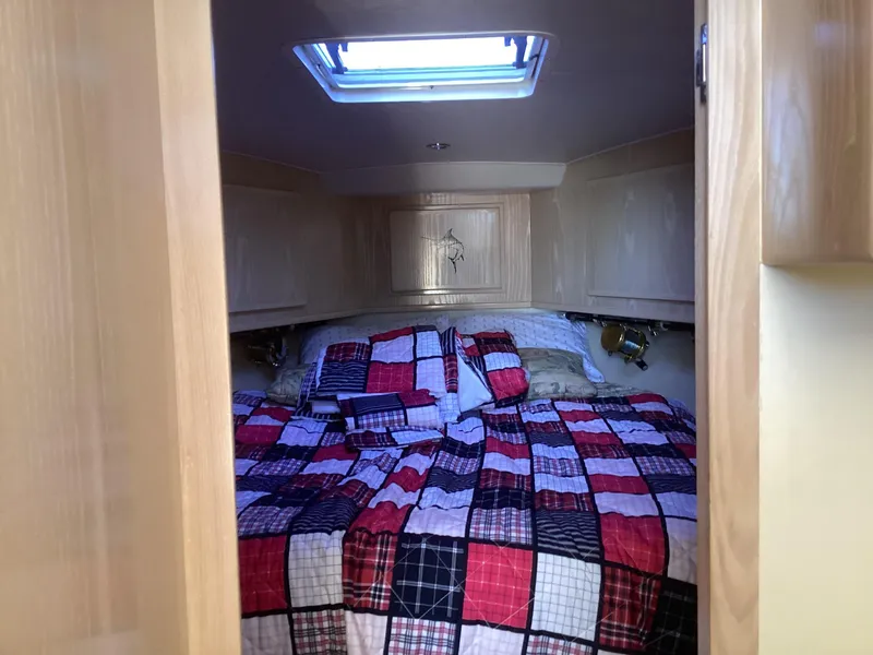 Slide: The Image of Cozy cabin interior of 2006 Henriques 35 Flybridge with colorful patchwork bedding. - 2