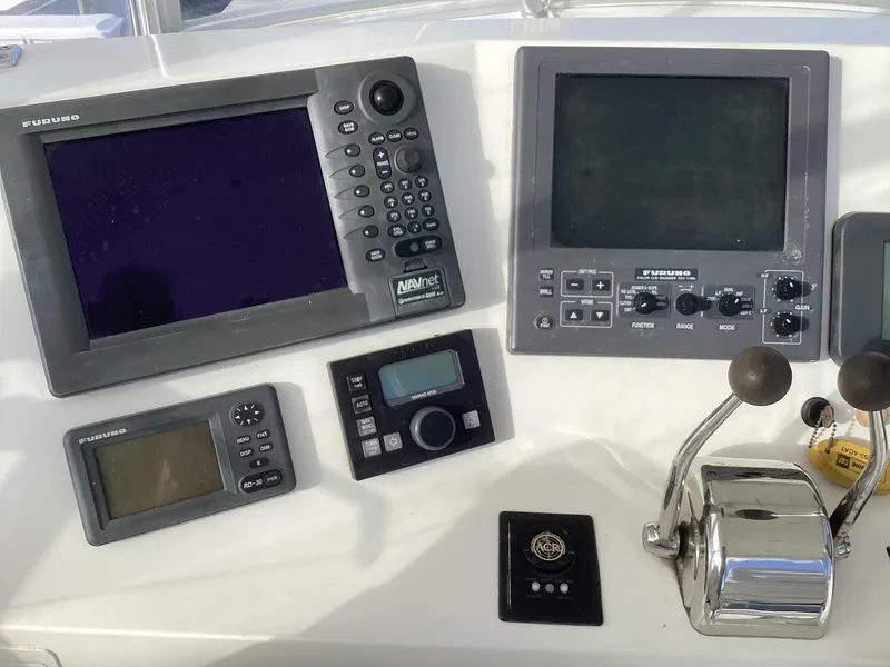 Slide: The Image of Control panel of 2006 Henriques 35 Flybridge with navigation and communication equipment. - 29