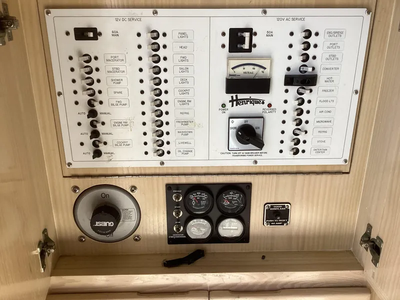 Slide: The Image of Electrical panel of a 2006 Henriques 35 Flybridge boat with gauges and switches. - 3
