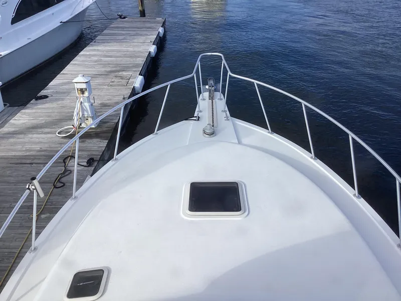 Slide: The Image of Henriques 35 Flybridge 2006 boat docked, view from bow, calm water. - 31