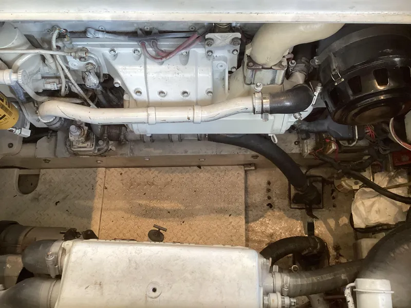 Slide: The Image of Engine compartment of a 2006 Henriques 35 Flybridge boat, showcasing mechanical components. - 32