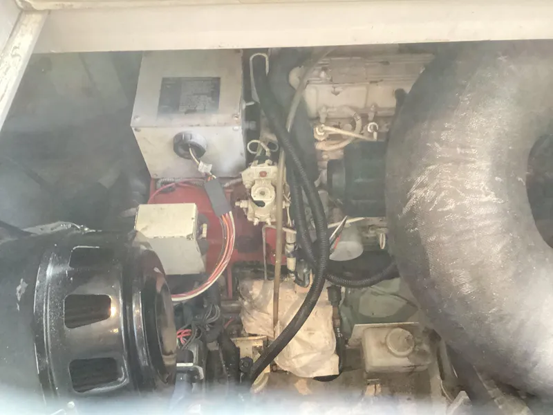 Slide: The Image of Engine compartment of a 2006 Henriques 35 Flybridge boat, showcasing mechanical components. - 34