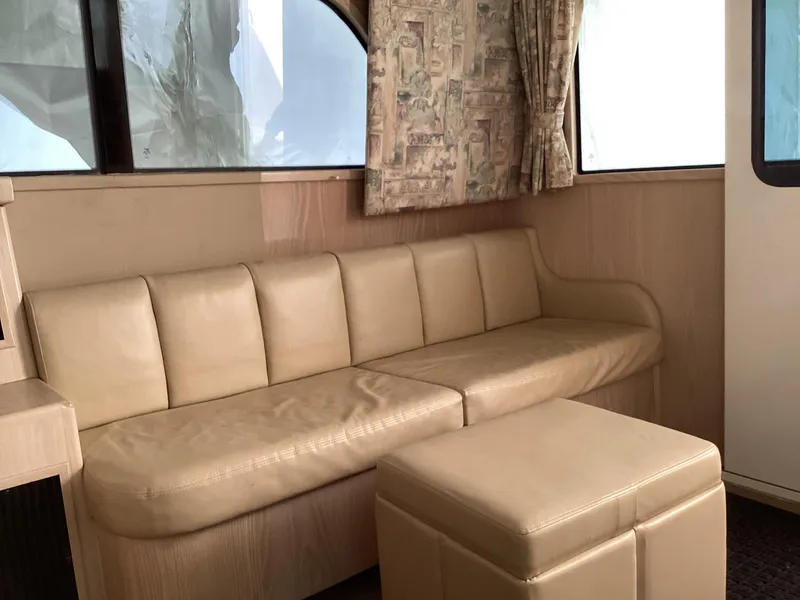 Slide: The Image of Interior of 2006 Henriques 35 Flybridge with beige leather seating and patterned curtains. - 39