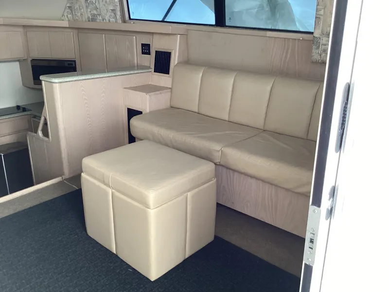 Slide: The Image of Interior of 2006 Henriques 35 Flybridge with beige seating and compact kitchen area. - 40