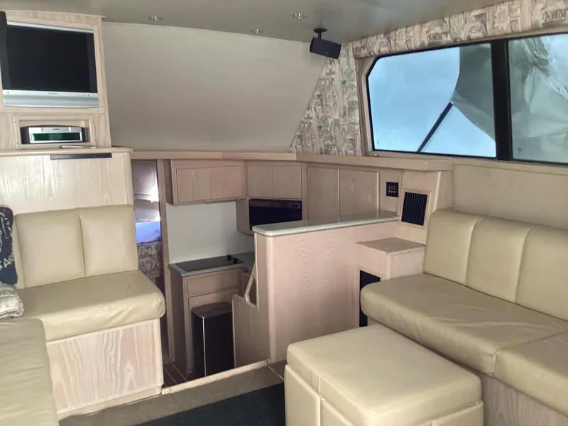 Slide: The Image of Interior of 2006 Henriques 35 Flybridge yacht with beige seating and compact kitchen area. - 41