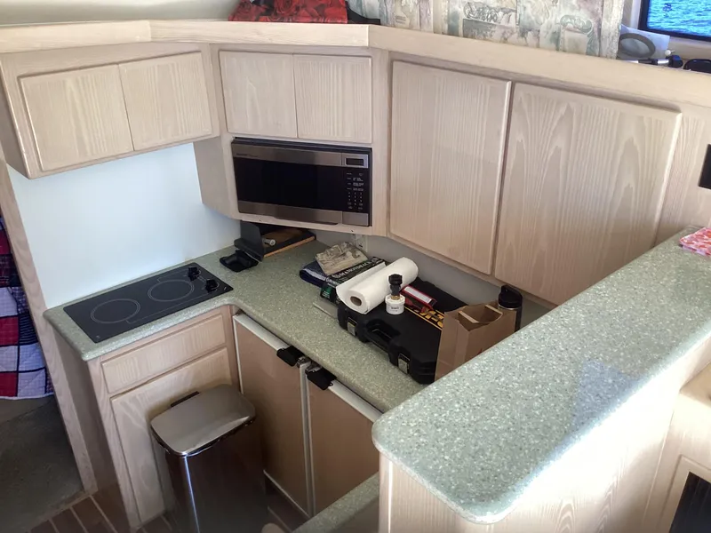 Slide: The Image of 2006 Henriques 35 Flybridge kitchen with modern appliances and light wood cabinetry. - 5