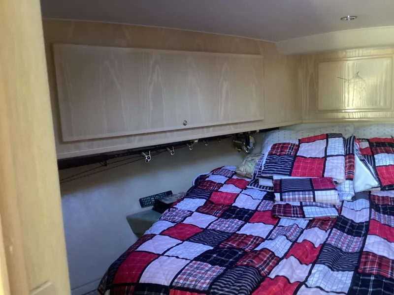 Slide: The Image of Cozy cabin interior of 2006 Henriques 35 Flybridge with colorful patchwork bedding. - 6