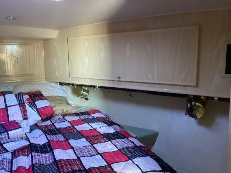 Slide: The Image of Cozy cabin interior of 2006 Henriques 35 Flybridge with colorful bedding and wood cabinetry. - 7