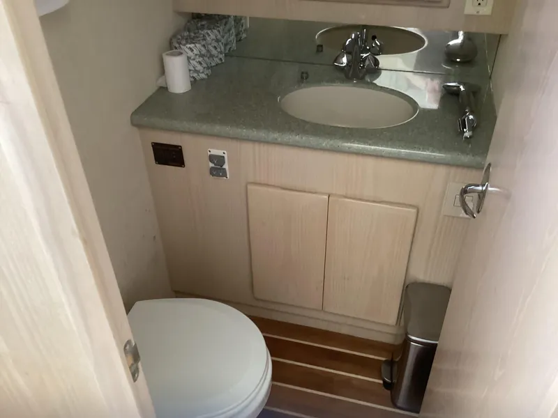 Slide: The Image of Henriques 35 Flybridge 2006 bathroom with sink, toilet, and wooden flooring. - 9