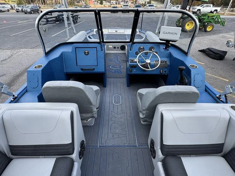 Slide: The Image of 2025 SeaArk Super Lounge Easy boat interior with blue and gray seating and Garmin navigation system. - 18