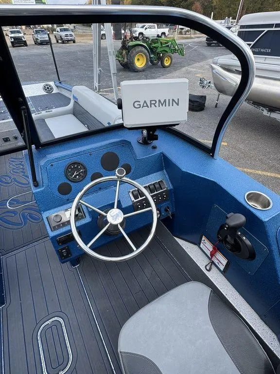 Slide: The Image of 2025 SeaArk Super Lounge Easy boat cockpit with Garmin navigation system. - 19